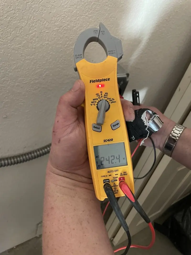 Voltage testing with clamp meter during Recessed Lighting Installation in Cutler